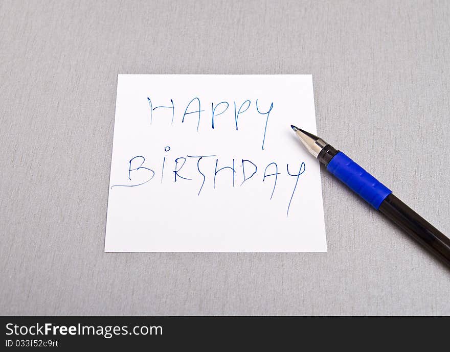 Happy Birthday message written on a white paper