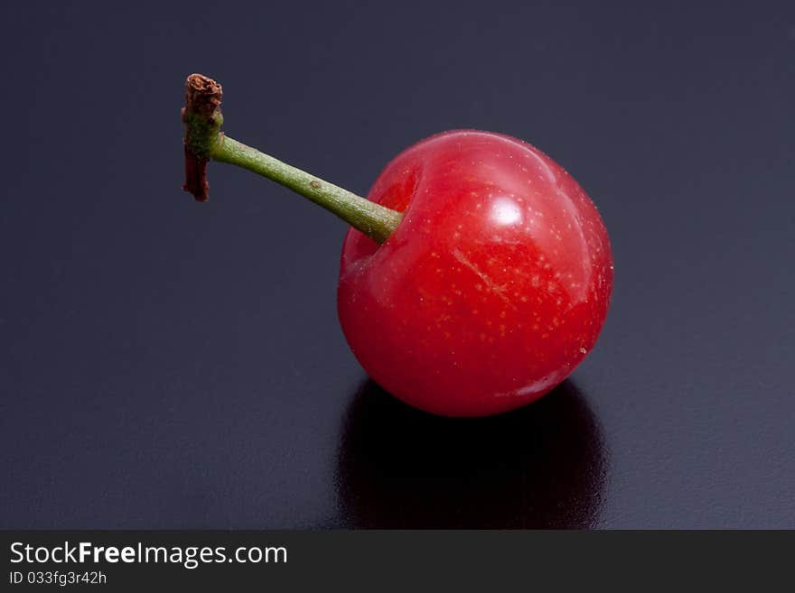 Fresh picked cherries still attached to their stem. Fresh picked cherries still attached to their stem