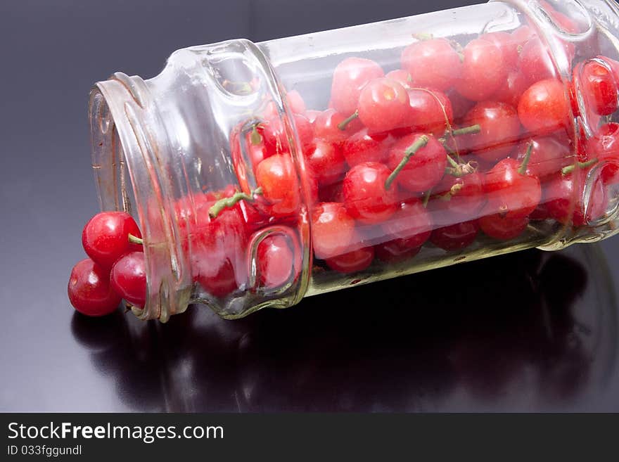 Fresh picked cherries still attached to their stem. Fresh picked cherries still attached to their stem