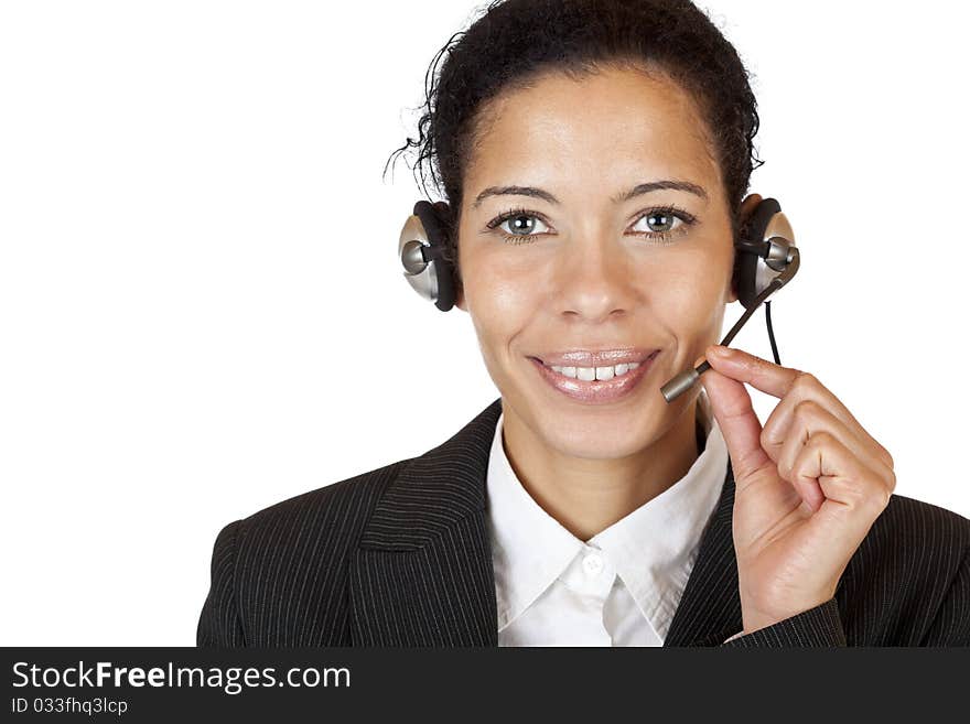 Smiling attractive woman makes with headset a call. Isolated on white background.