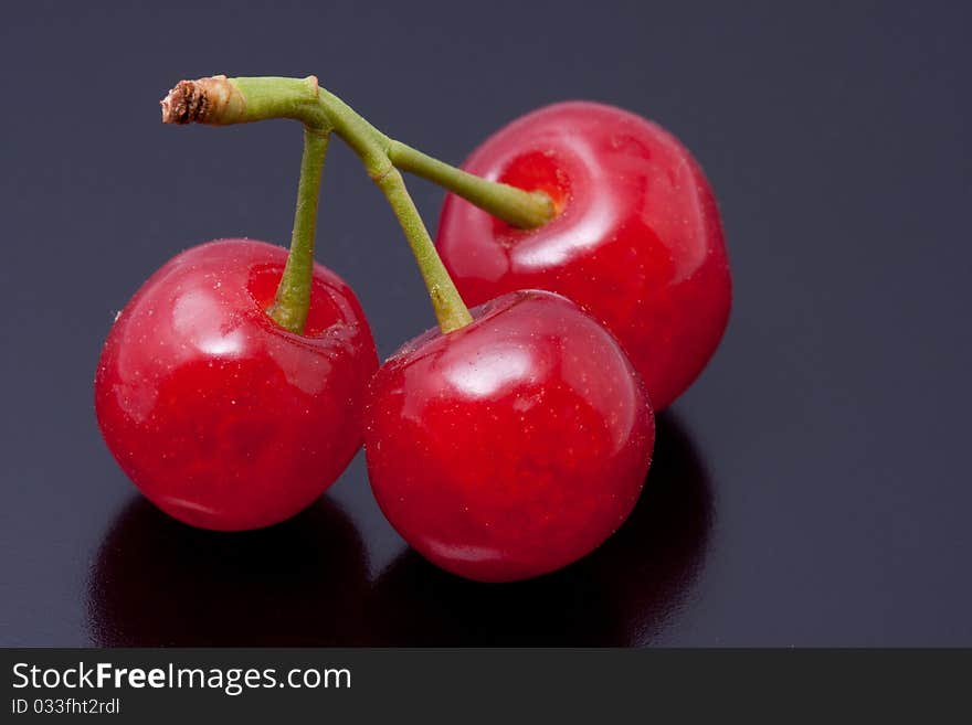 Fresh picked cherries still attached to their stem. Fresh picked cherries still attached to their stem