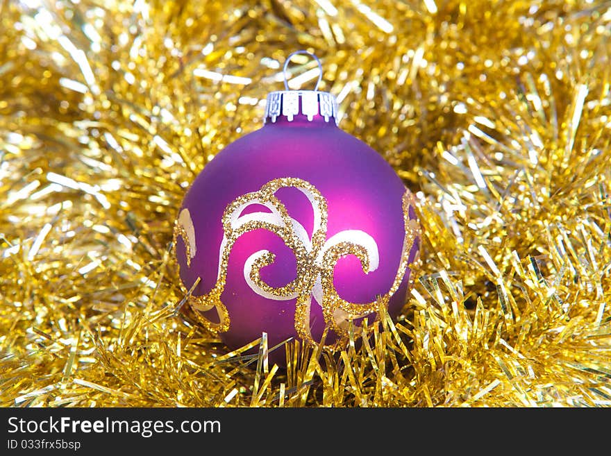 Purple christmas ball in gold decorations