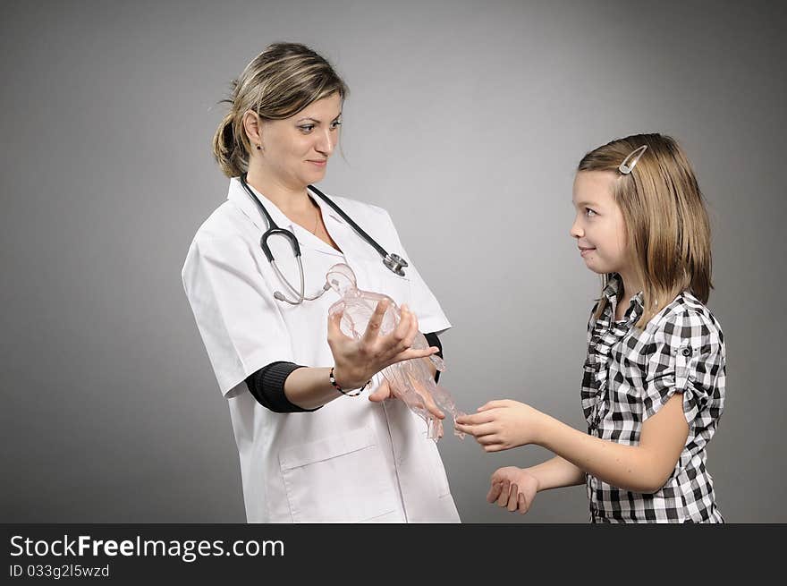 Girl learning and doctor presenting human body structure. Girl learning and doctor presenting human body structure