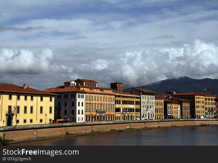 Colorful buildings by the Arno river in Pisa, Tuscany, Italy