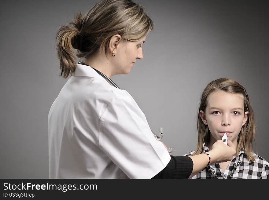 Young doctor examining white girl. Young doctor examining white girl