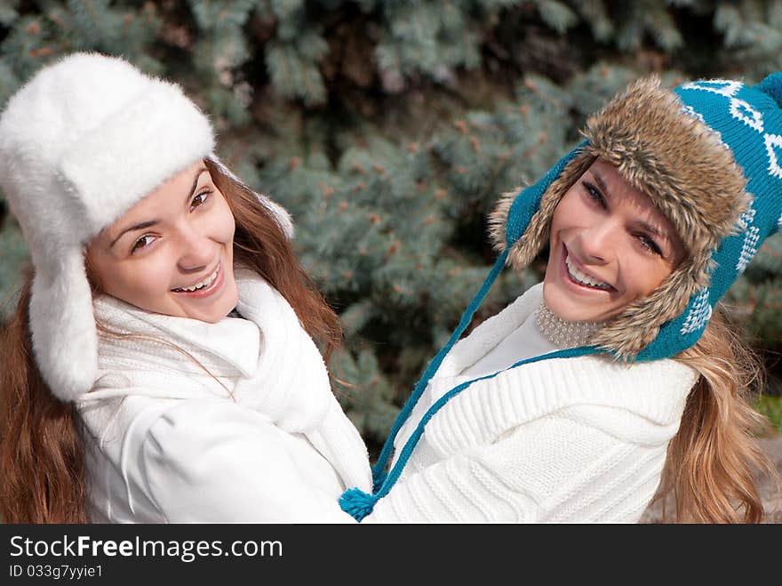 Happy two cheerful girls twins, in the park