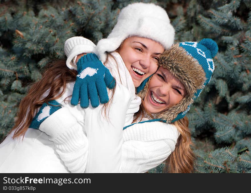 Happy two cheerful girls twins, in the park