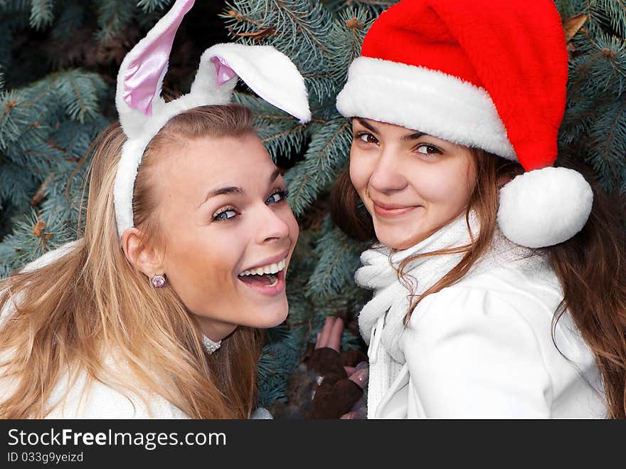 Two cheerful girls twins, in the park