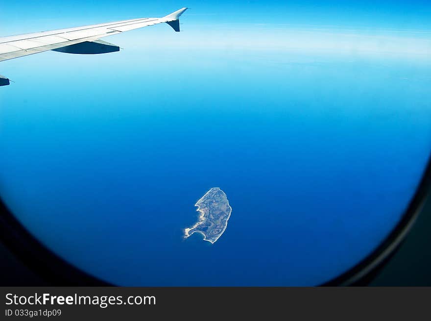 View of an island from the window of a plane. View of an island from the window of a plane