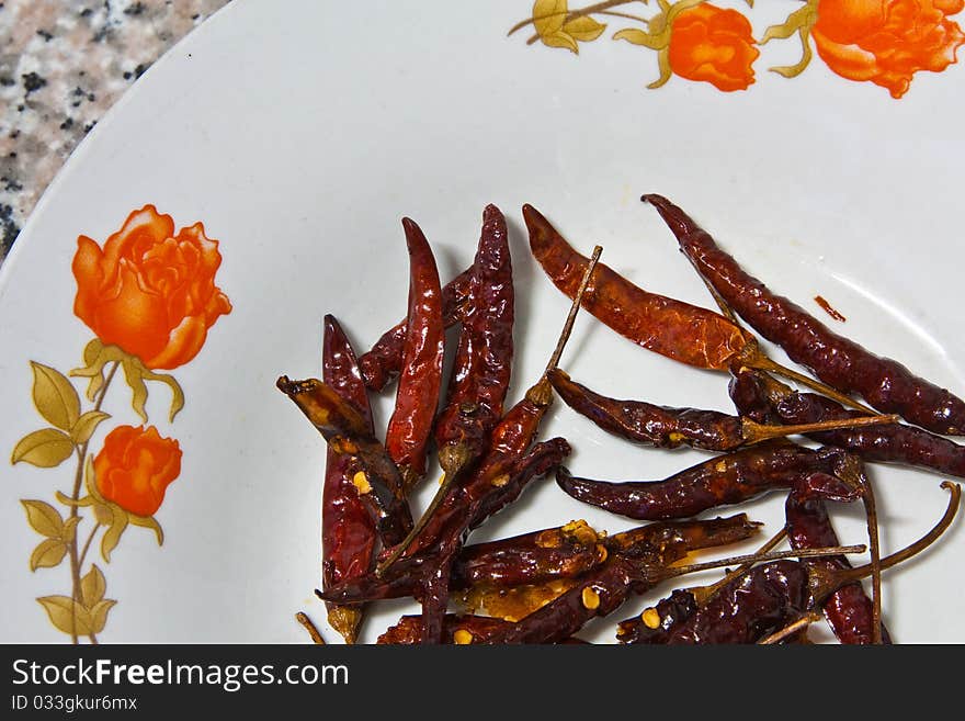 Red chile on the white plate. Red chile on the white plate