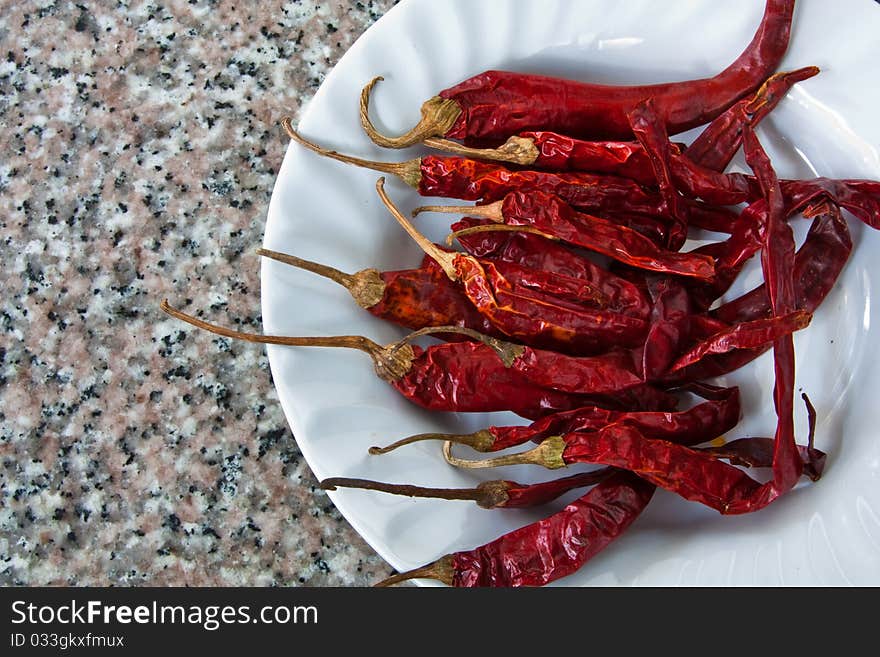 Red chile on the white plate. Red chile on the white plate