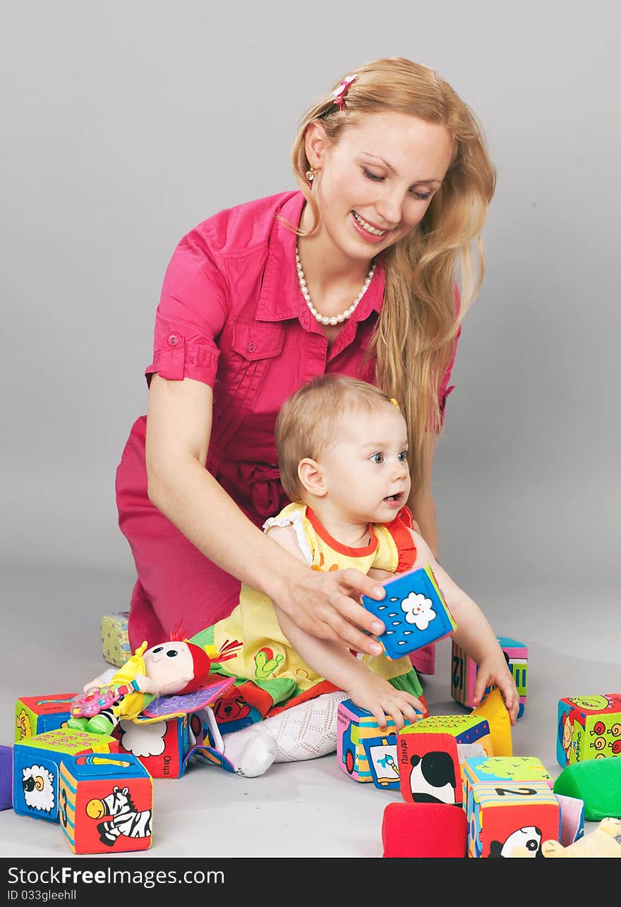 Mother and daughter playing with colorful bricks. Mother and daughter playing with colorful bricks