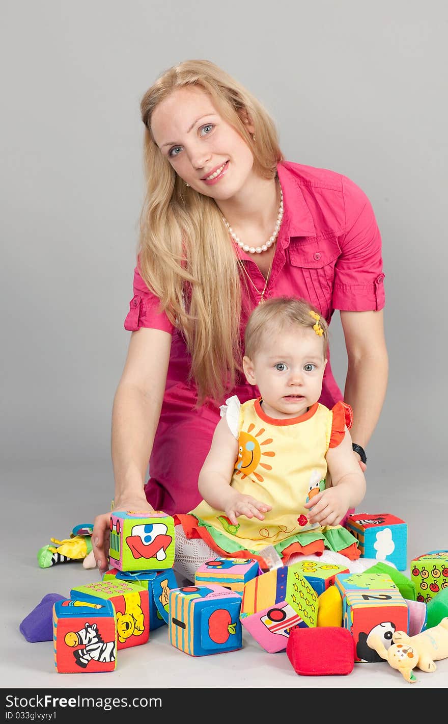 Mother and daughter playing with colorful bricks. Mother and daughter playing with colorful bricks