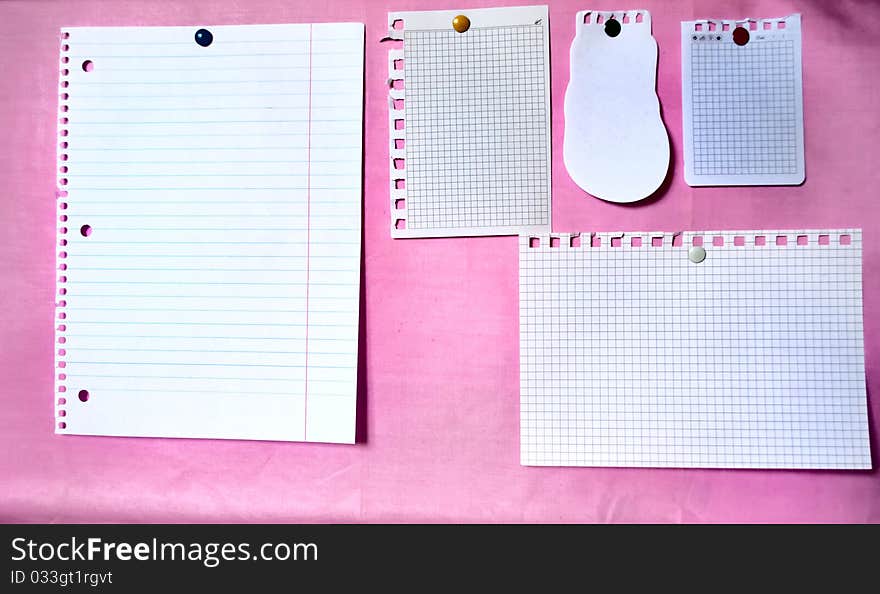 White sheets on the pink bulletin board. White sheets on the pink bulletin board