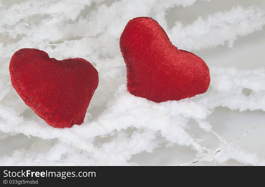 Two hearts between branches covered with snow for Valentine's Day