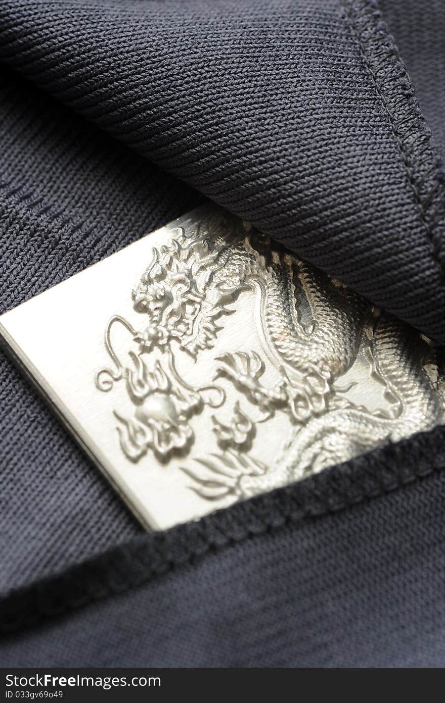 An engraving dragon plate hiding in a black cloth. An engraving dragon plate hiding in a black cloth.