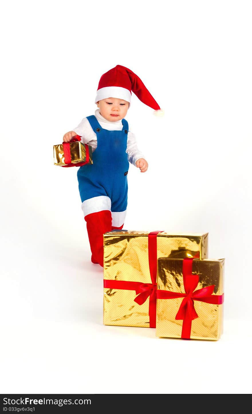 Little Boy In Santa Hat With A Bunch Of Gifts