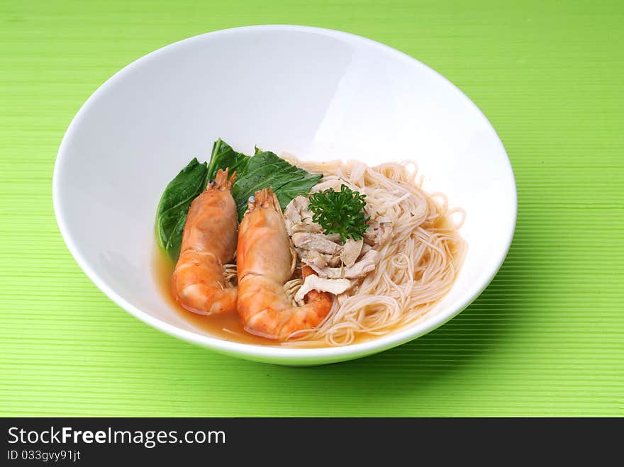 Chinese style seafood noodles in a white bowl