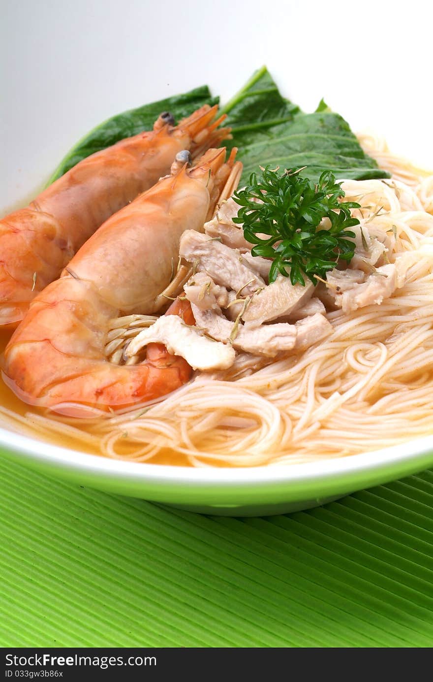 Chinese style seafood noodles in a white bowl