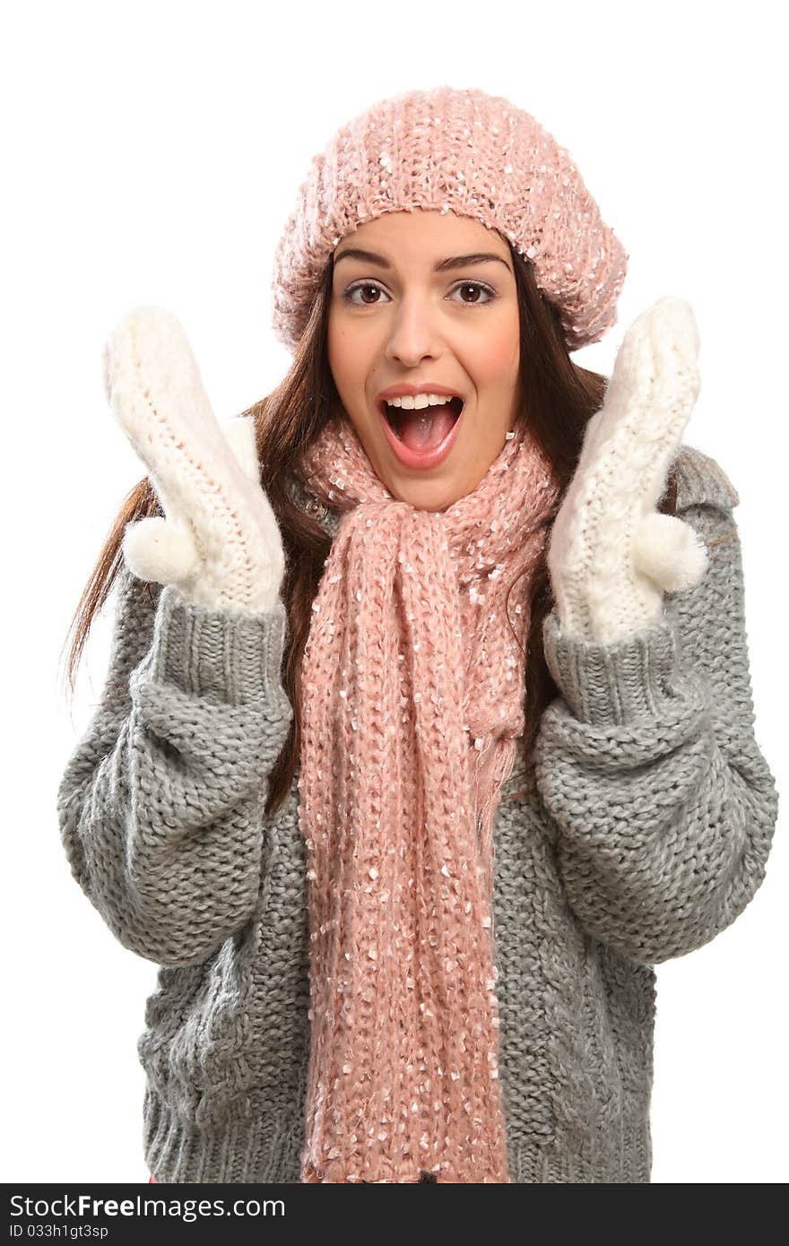 Surprised expression from a beautiful young woman with big happy laugh wrapped up warm in winter woollies, including mits, hat, scarf and jumper. Surprised expression from a beautiful young woman with big happy laugh wrapped up warm in winter woollies, including mits, hat, scarf and jumper.