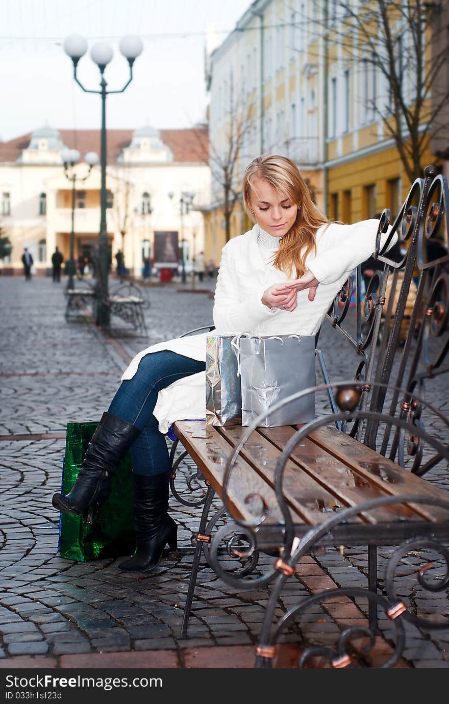 Young Woman Sitting On A Bench