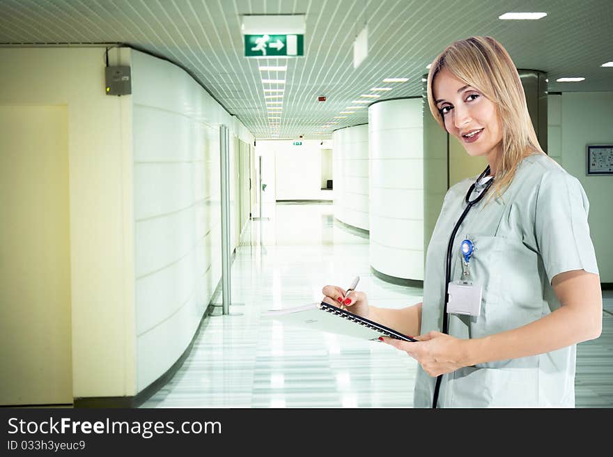 Smiling confident medical staff standing in her uniform. Smiling confident medical staff standing in her uniform