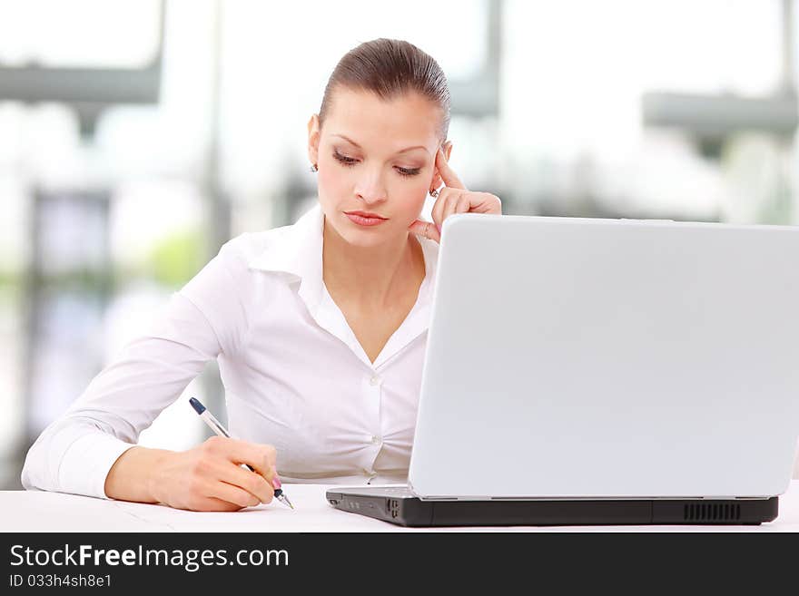 Portrait of an adorable business woman working at her desk