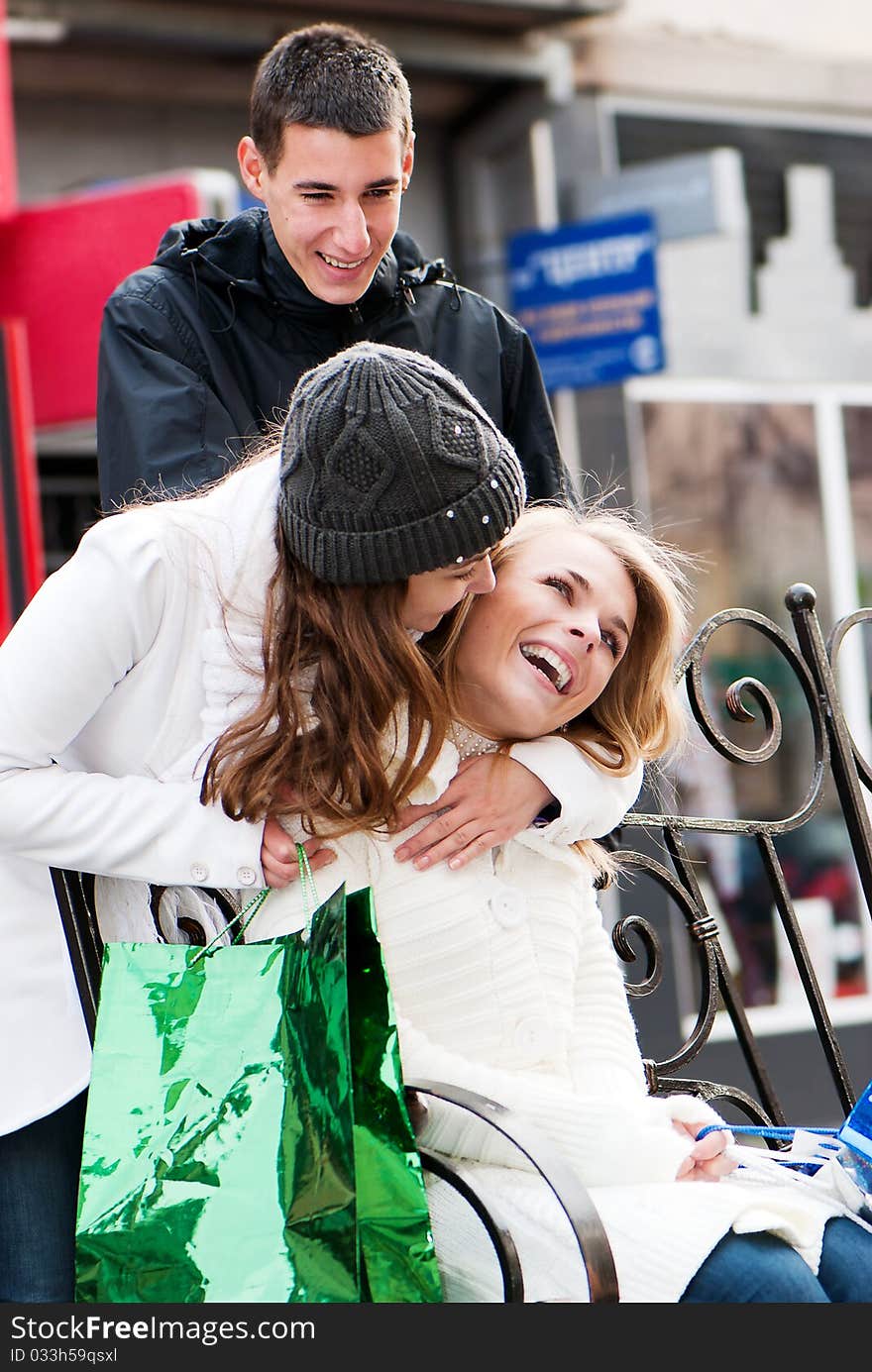 Happy friends with a New Year's gift in the street