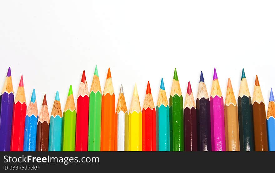 Color pencils in arrange in color wheel colors on white background. Color pencils in arrange in color wheel colors on white background