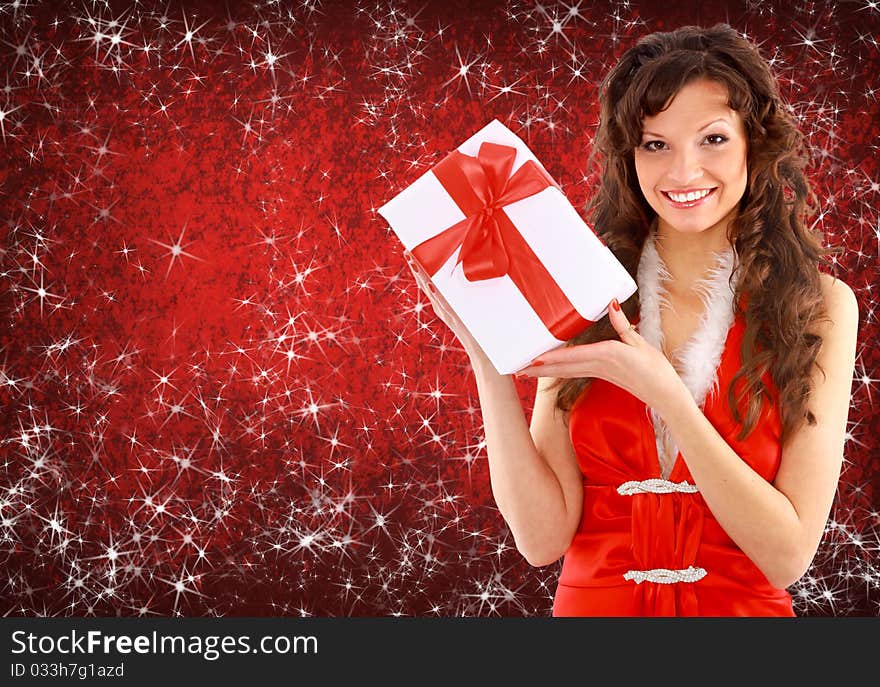 Portrait of a beautiful young woman wearing christmas clothes over sky of stars and snow.