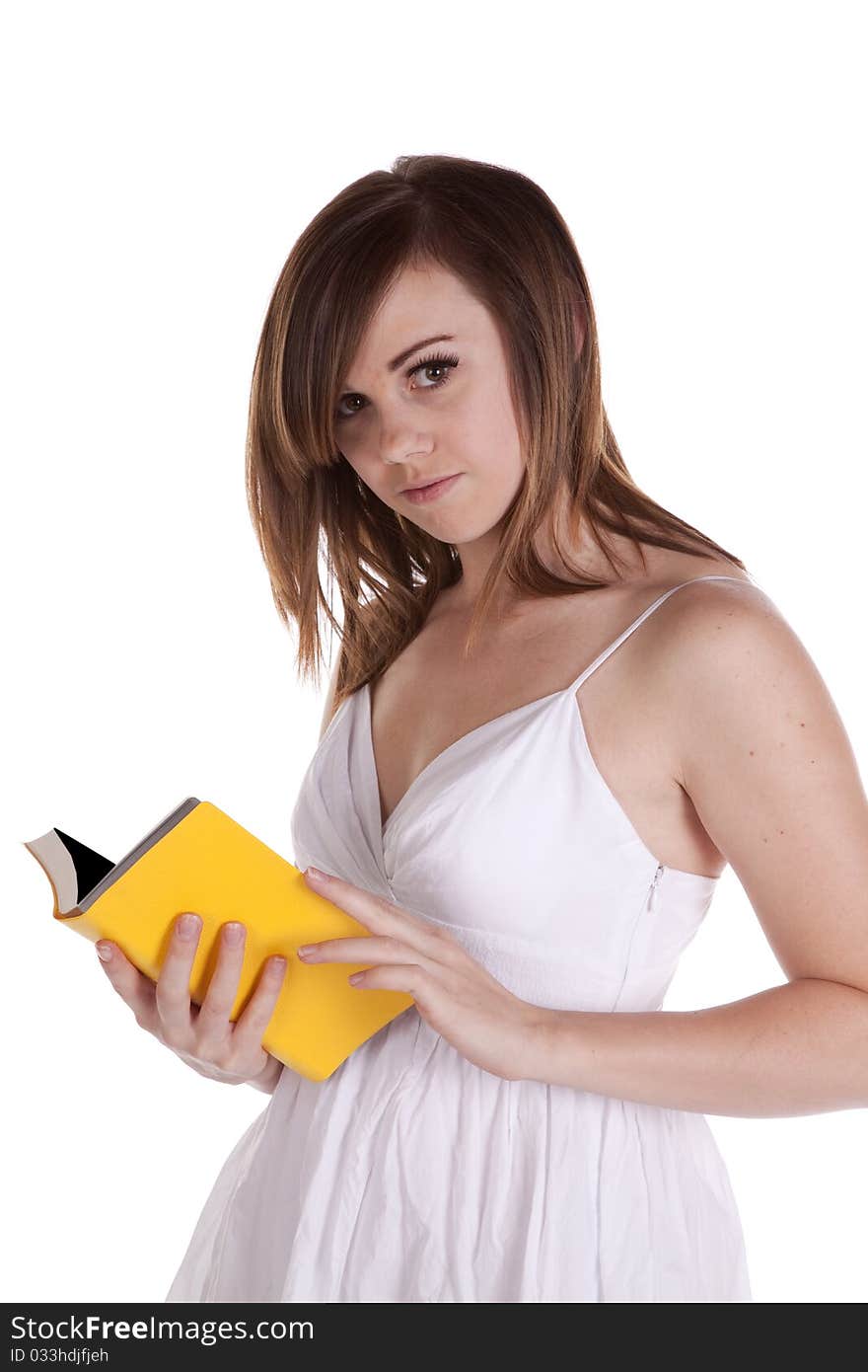 A woman looking up as she holds her yellow book open. A woman looking up as she holds her yellow book open.