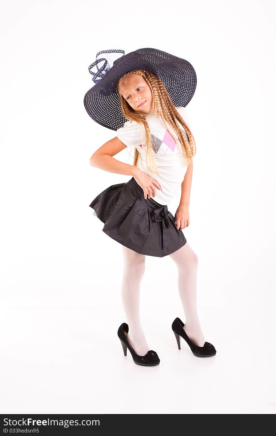 Funny girl in big hat and mum's shoes, isolated on white. Funny girl in big hat and mum's shoes, isolated on white