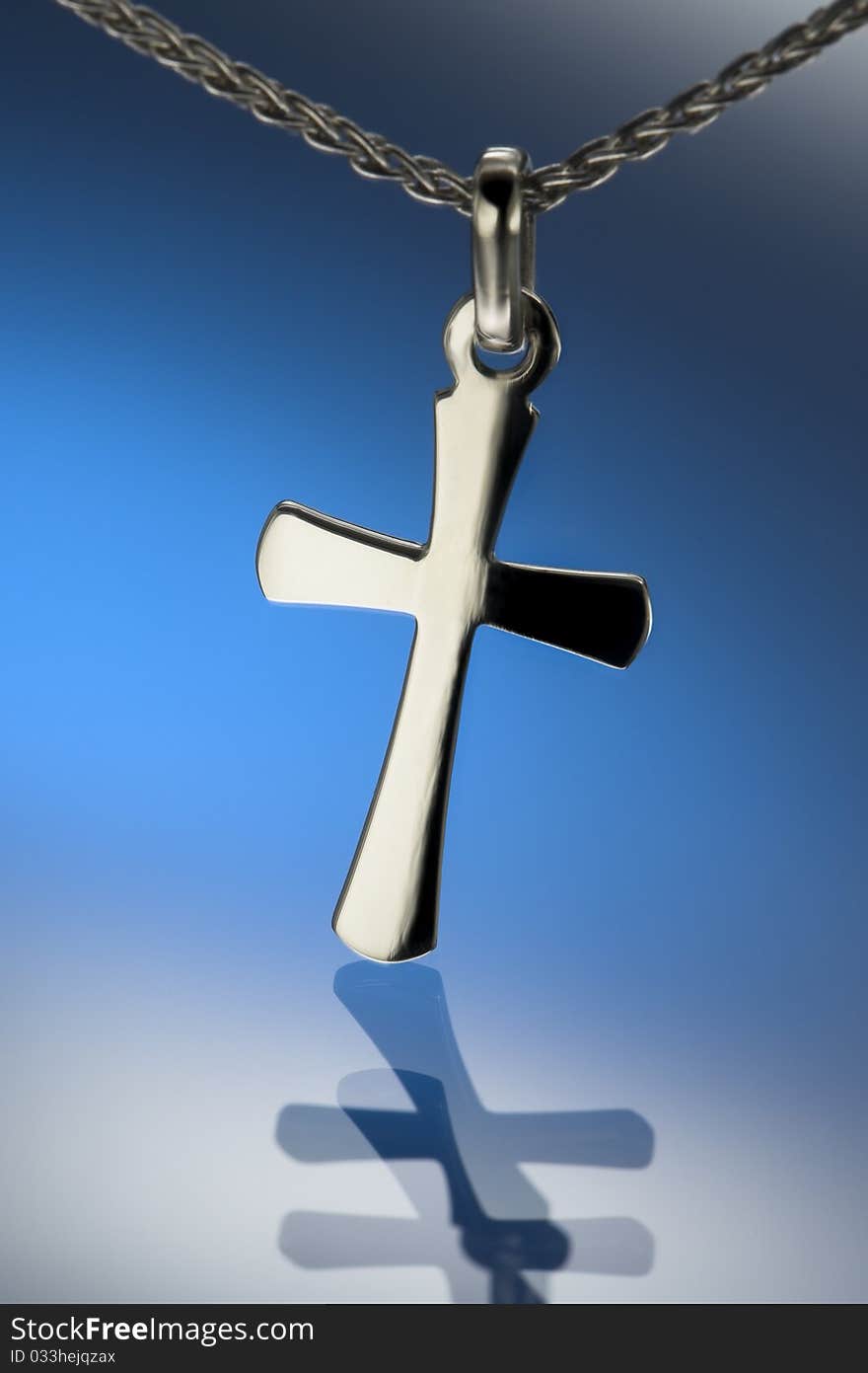 Cross medalion with neclace, blue background. Cross medalion with neclace, blue background