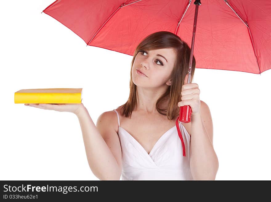 A woman under a red umbrella holding her yellow book out on her hand. A woman under a red umbrella holding her yellow book out on her hand.