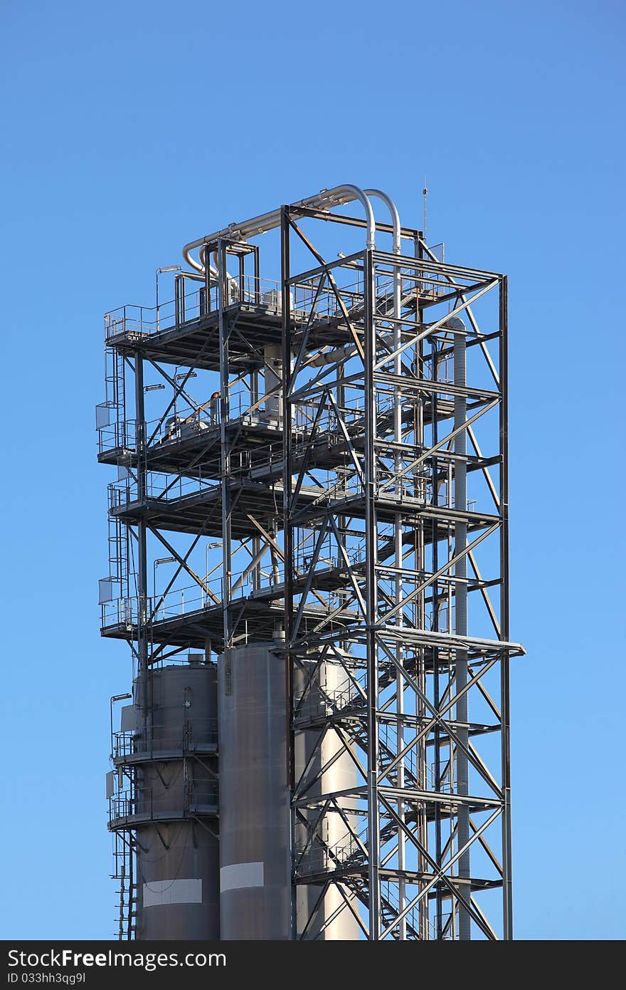 Tower structure in an oil refinery over blue sky. Tower structure in an oil refinery over blue sky