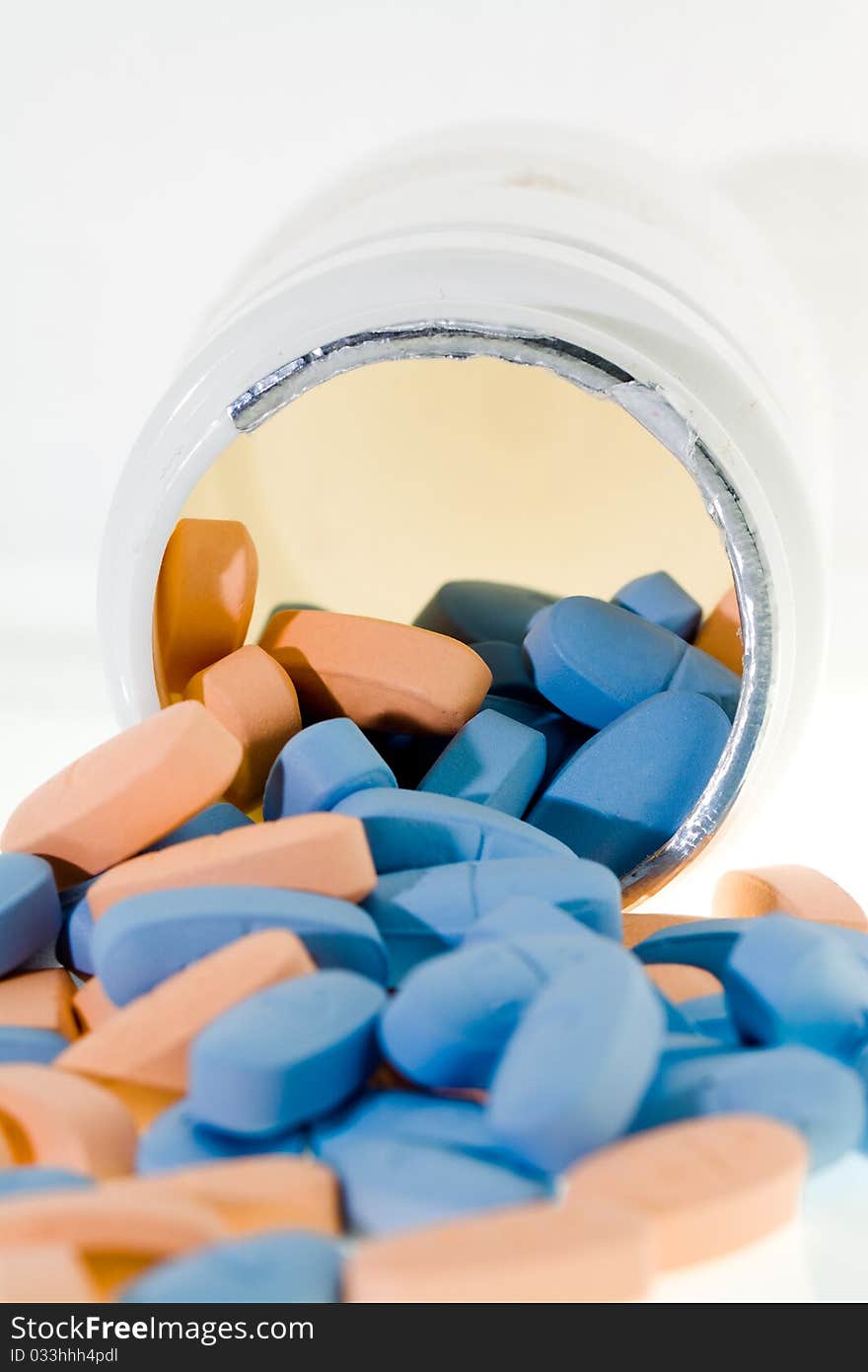 The multi-colored tablets lying near an open box for tablets. The multi-colored tablets lying near an open box for tablets