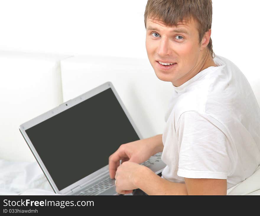 Rear view closeup of a young man working of a laptop