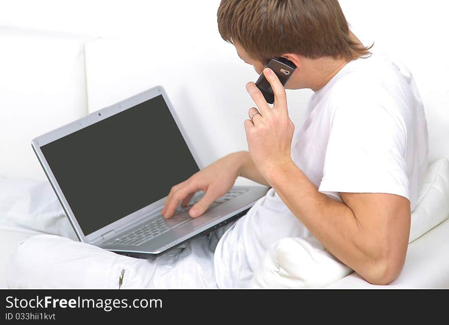 Rear view closeup of a young man working of a laptop