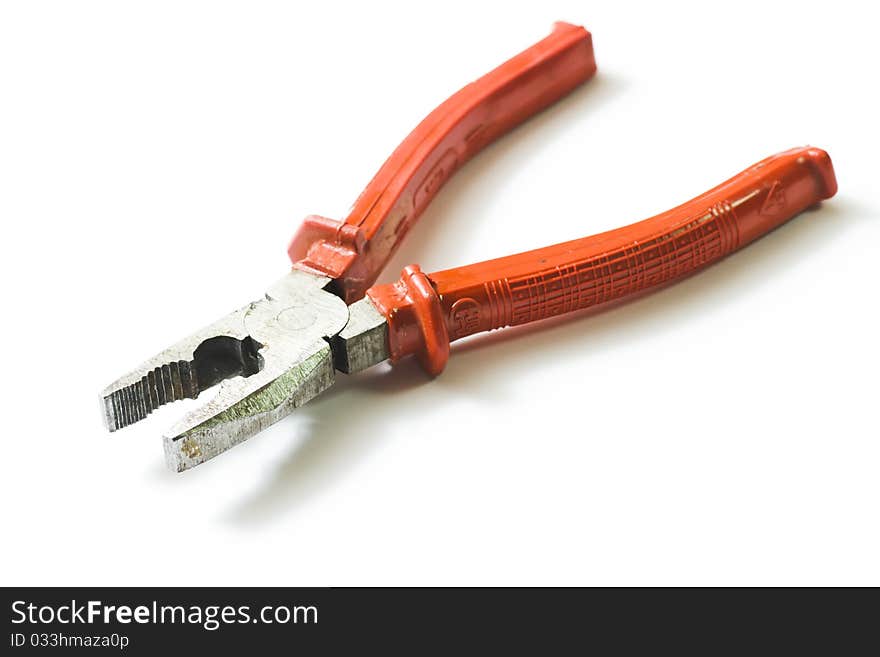 Metal pliers with orange grip isolated on white background