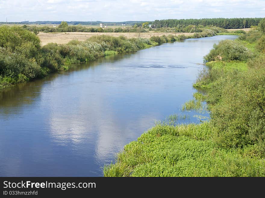 Small blue river surround the green banks.