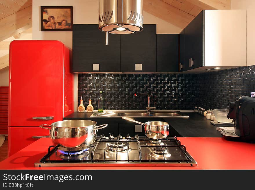 Modern mansard with red kitchen