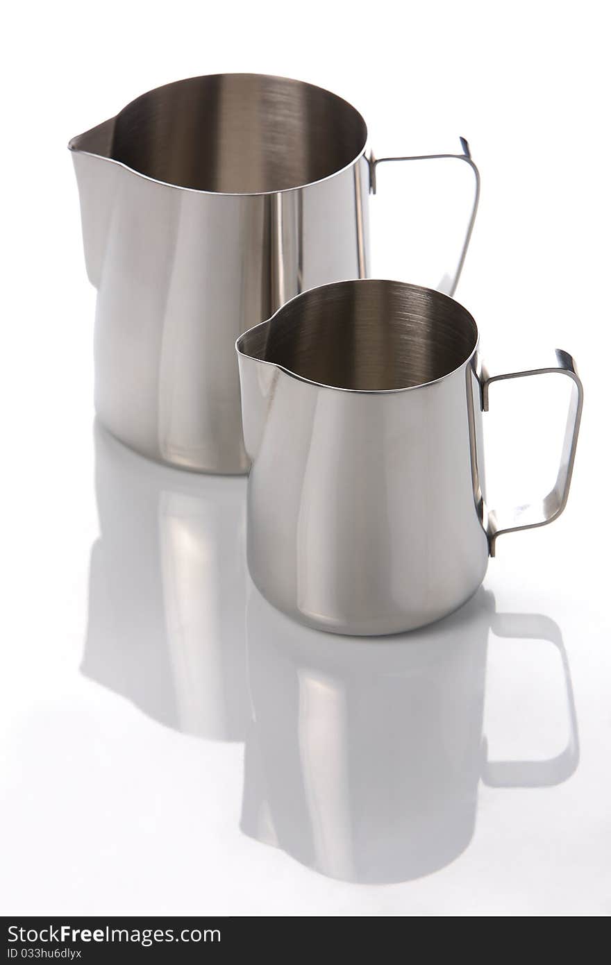 Two metal jugs on a white background