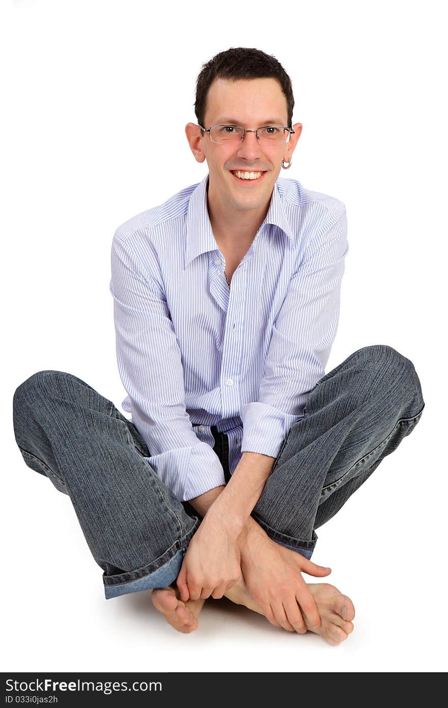 Full portrait of smiling handsome man sitting on the flor. Full portrait of smiling handsome man sitting on the flor