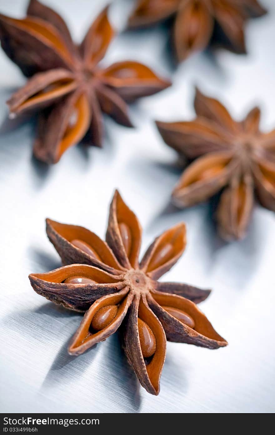 Star anise on grey brushed metal background (low DOF)