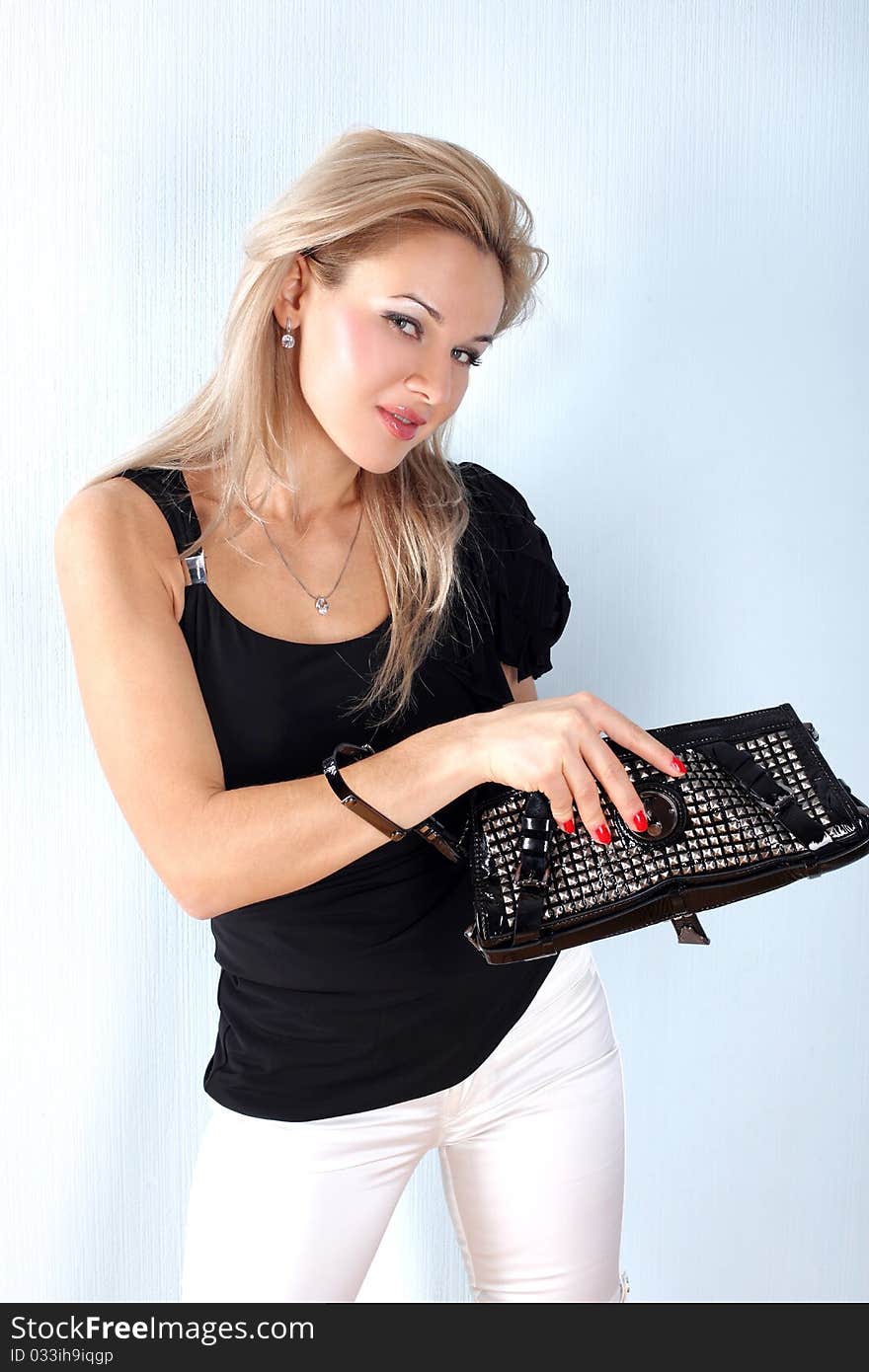 Fashion young woman with clutch bag