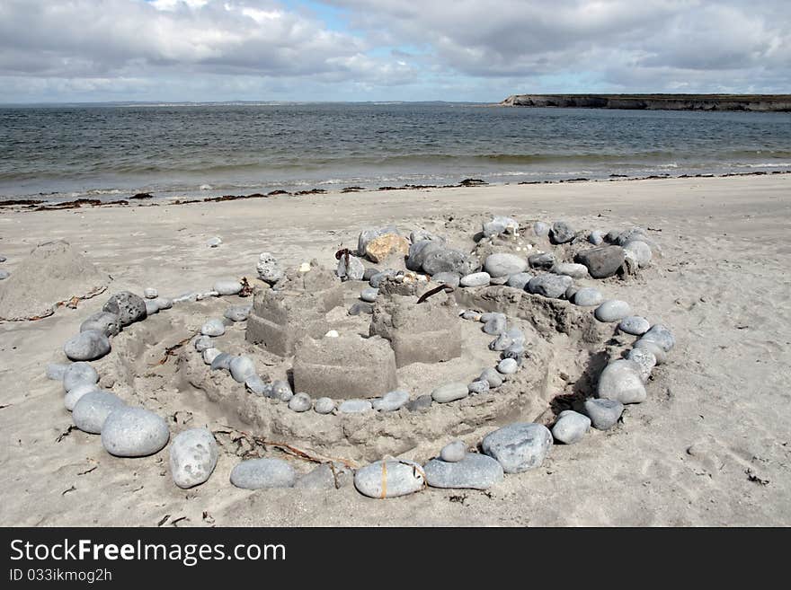 A sandcastle made with stones and sand on an irish shore. A sandcastle made with stones and sand on an irish shore