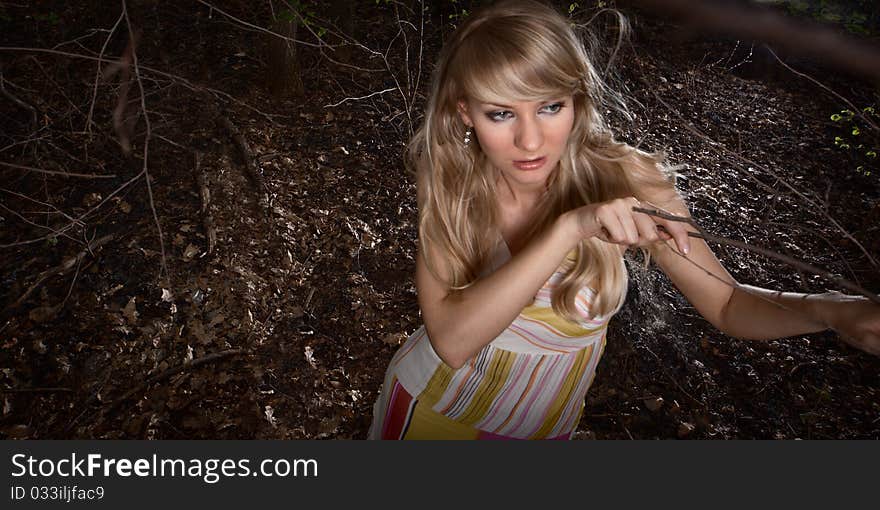 Wide-angle portrait of a young lady in a dark forest. Wide-angle portrait of a young lady in a dark forest