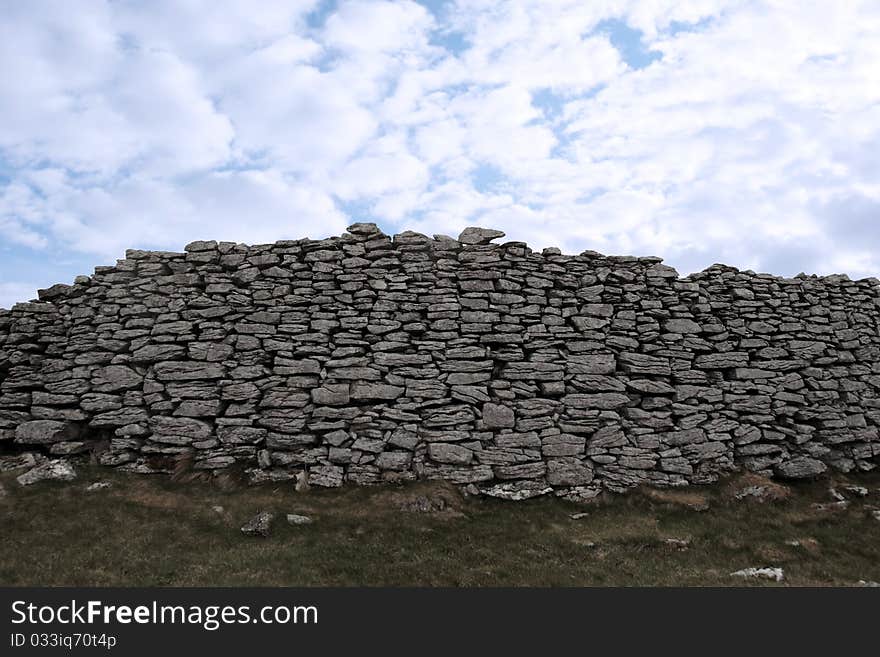 Rocky boundary walls in scenic west ireland with a cloudy background. Rocky boundary walls in scenic west ireland with a cloudy background