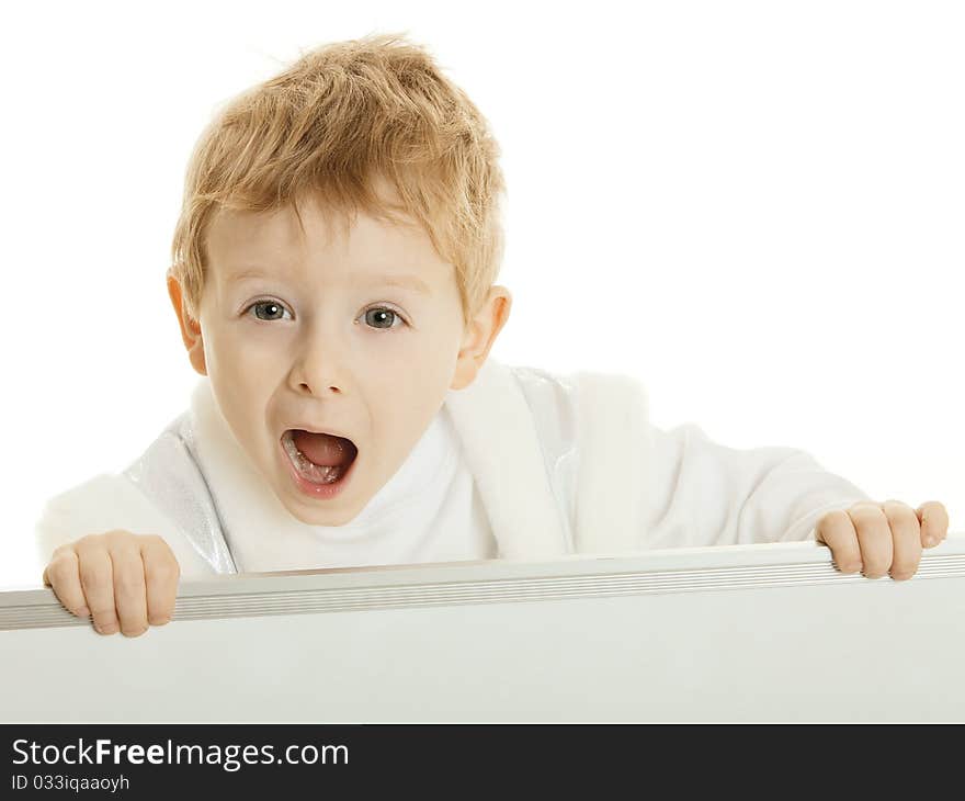 The little boy has control over a bulletin board and loudly shouts. The little boy has control over a bulletin board and loudly shouts