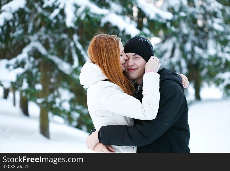 Young pair walks in wood, winter. Young pair walks in wood, winter